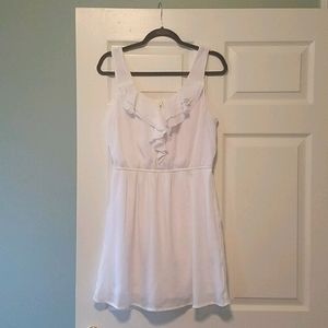 White sleeveless dress with front ruffle